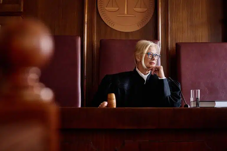 Judge in courtroom holding gavel