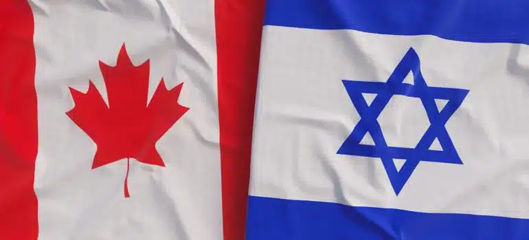 Folded Canadian and Israeli flags next to each other.