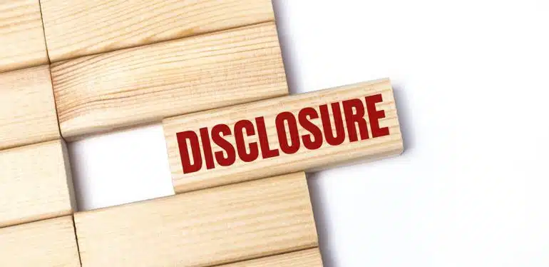 Several blank wooden blocks with one stamped with the word Disclosure offset from the rest.